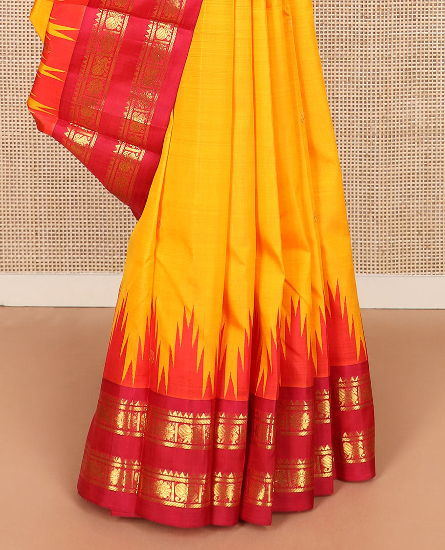 Yellow zari buttas Kanchipuram silk saree, contrast thazampoo rekku border of rekku, banaras, and mayil chakram designs, and zari design pallu