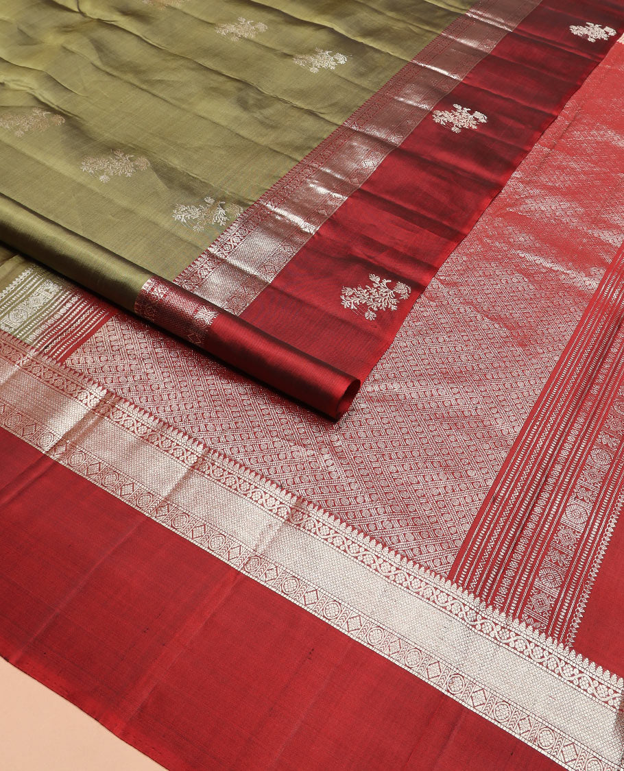 Green zari buttas Kanchipuram silk saree, contrast border of thilakam, muthu, kodi visiry, mayil kann, chakra, and diamond designs, and rudraksham motifs pallu