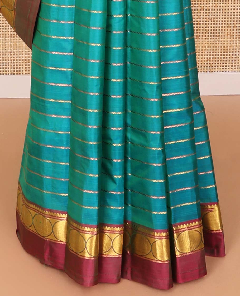 Dark blue striped kancheepuram with contrast border of paisley, muthu, kathir design & zari design pallu