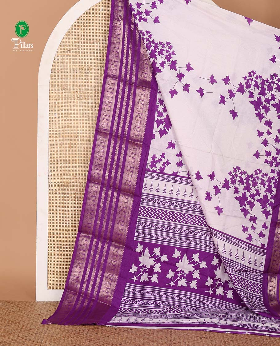 White leaf printed dola silksaree,contrast gold zari border of traditional motifs, geometric printed pallu & printed violet blouse