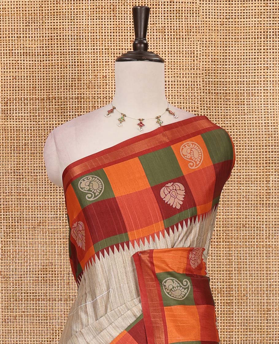 Chikku- orange plain kathan silk saree, contrast buttas enclosed multi-color checked blocks border, temple pallu, and contrast blouse of checks, and buttas