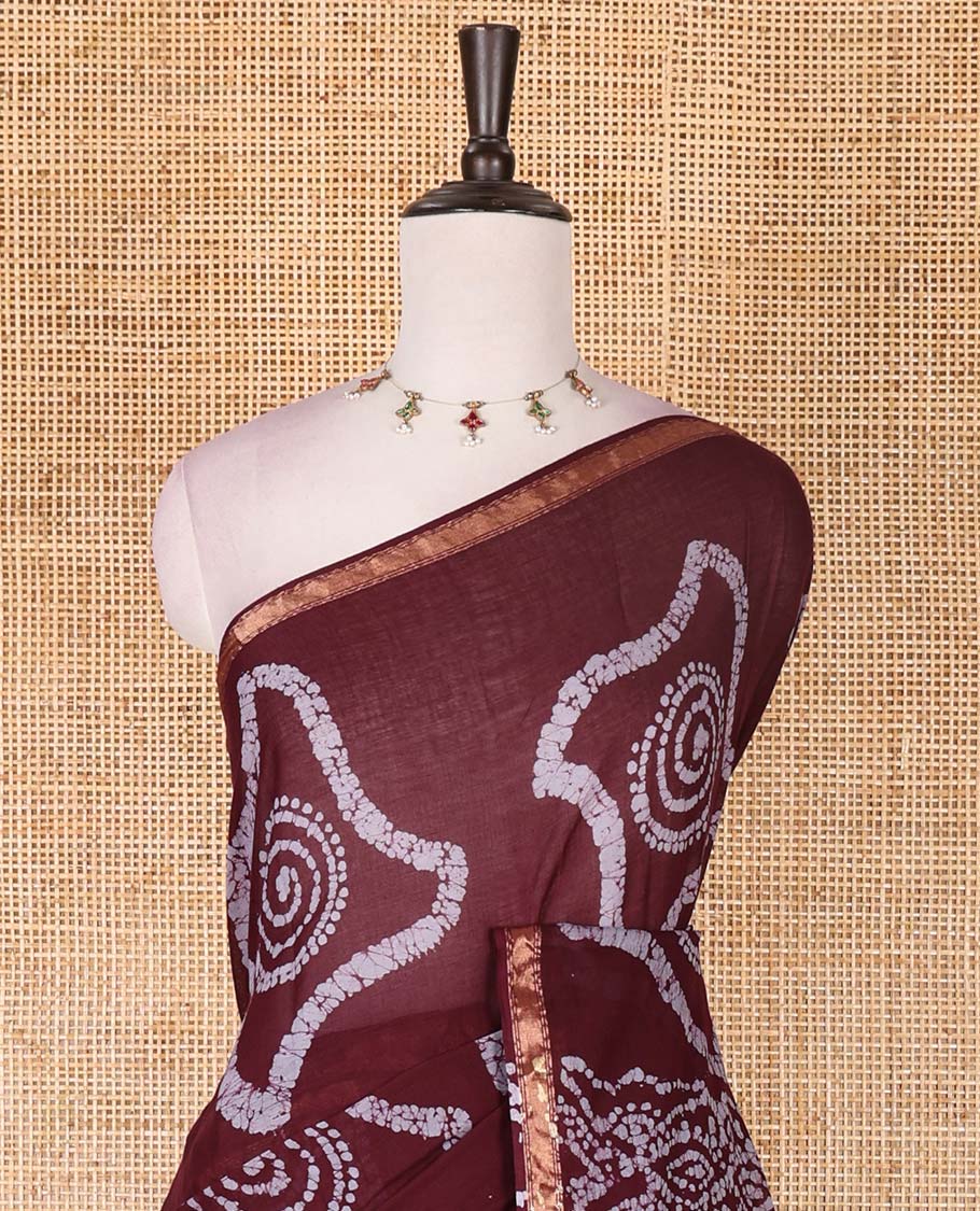 Wine batik geometric printed pure cotton saree, zari piping border, human figurines batik printed pallu, and a matching batik printed blouse