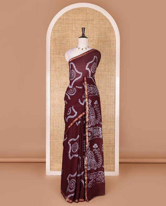 Wine batik geometric printed pure cotton saree, zari piping border, human figurines batik printed pallu, and a matching batik printed blouse