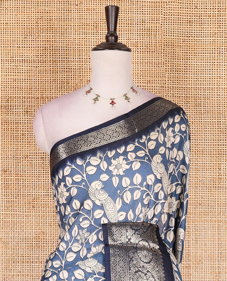 Blue kalamkari floral vine and peacock printed dola silk saree, contrast traditional zari border, peacock printed pallu, and floral vine print blouse