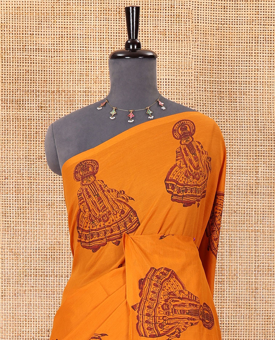 Borderless yellow kolam and kathakali motifs printed South cotton saree with a matching blouse, and a contrast floral vine printed blouse