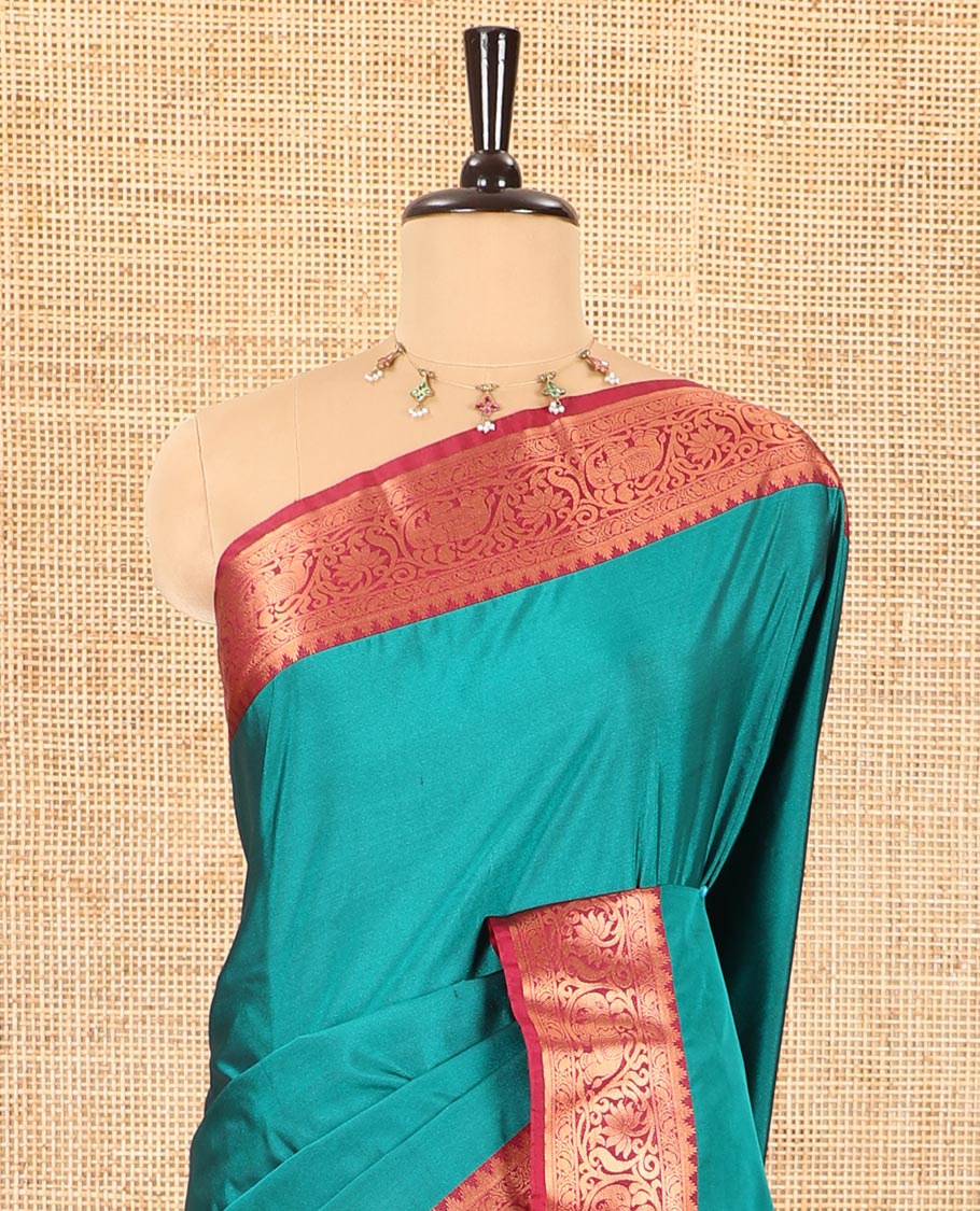 Peacock green plain luxury soft silk saree, contrast traditional temple zari border of elephant motifs, geometric zari pallu, and a contrast jacquard blouse
