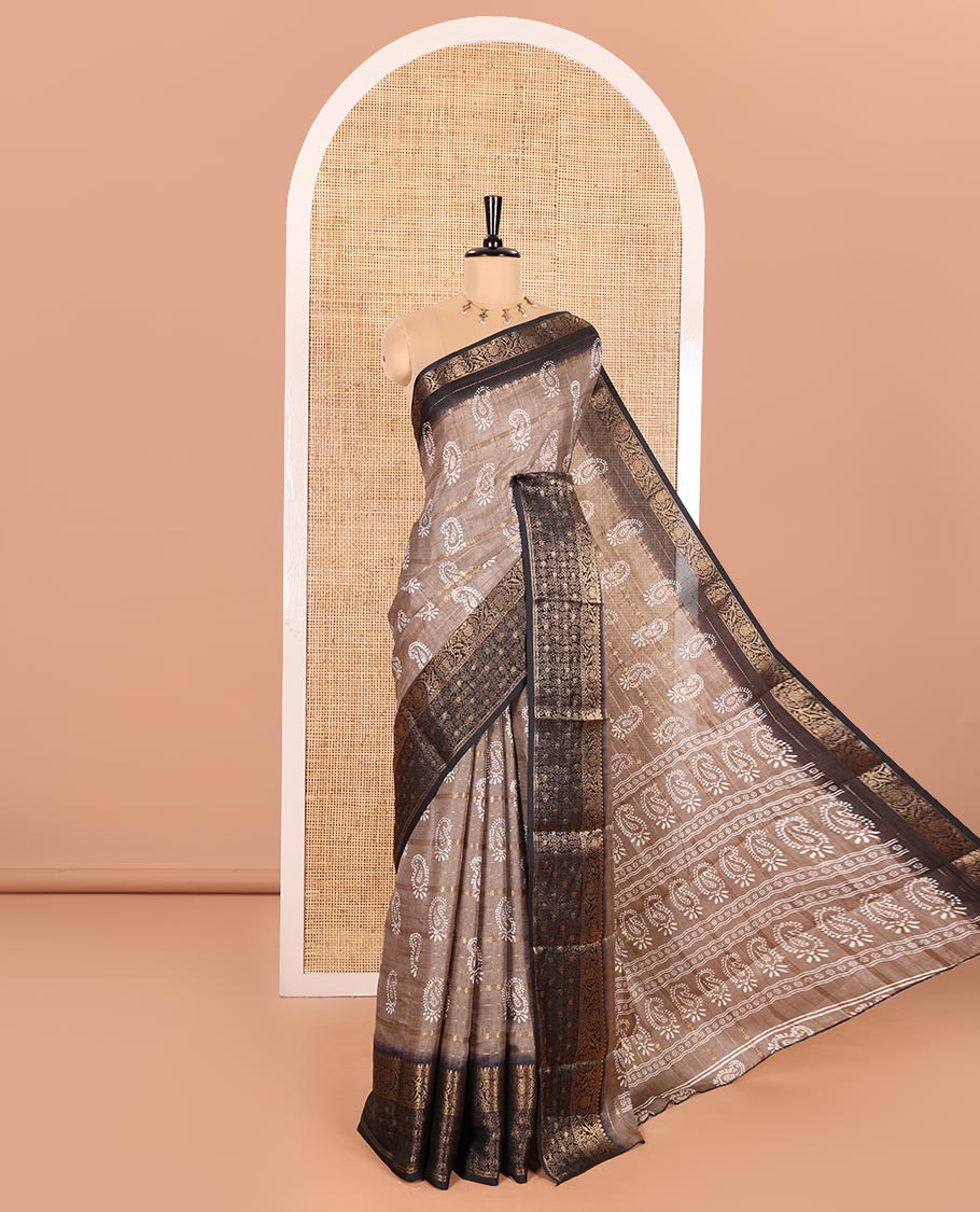 Brown Dola Silk Saree Decked Up with Paisley Buttas, and Horizontal Zari Stripes All Over Its Body, Complemented by Contrast Floral Creeper Zari Design Border, Pallu Steeped with Paisleys, and Paired with a Contrast Blouse