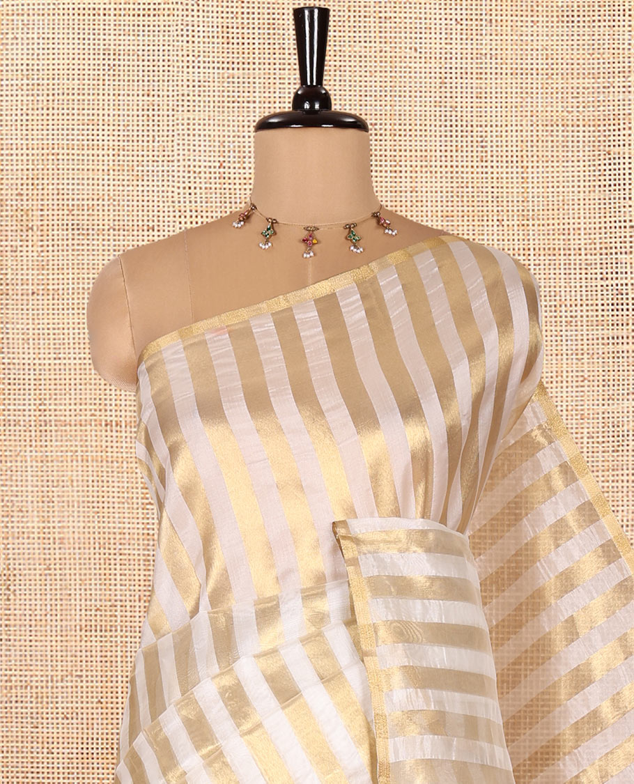 Borderless Off-white Tissue Saree, Entralled with Thick Vertical Golden Zari Stripes All Over Its Body, Highlighted by Gleaming Zari Striped Pallu, and Paired with a Matching Blouse