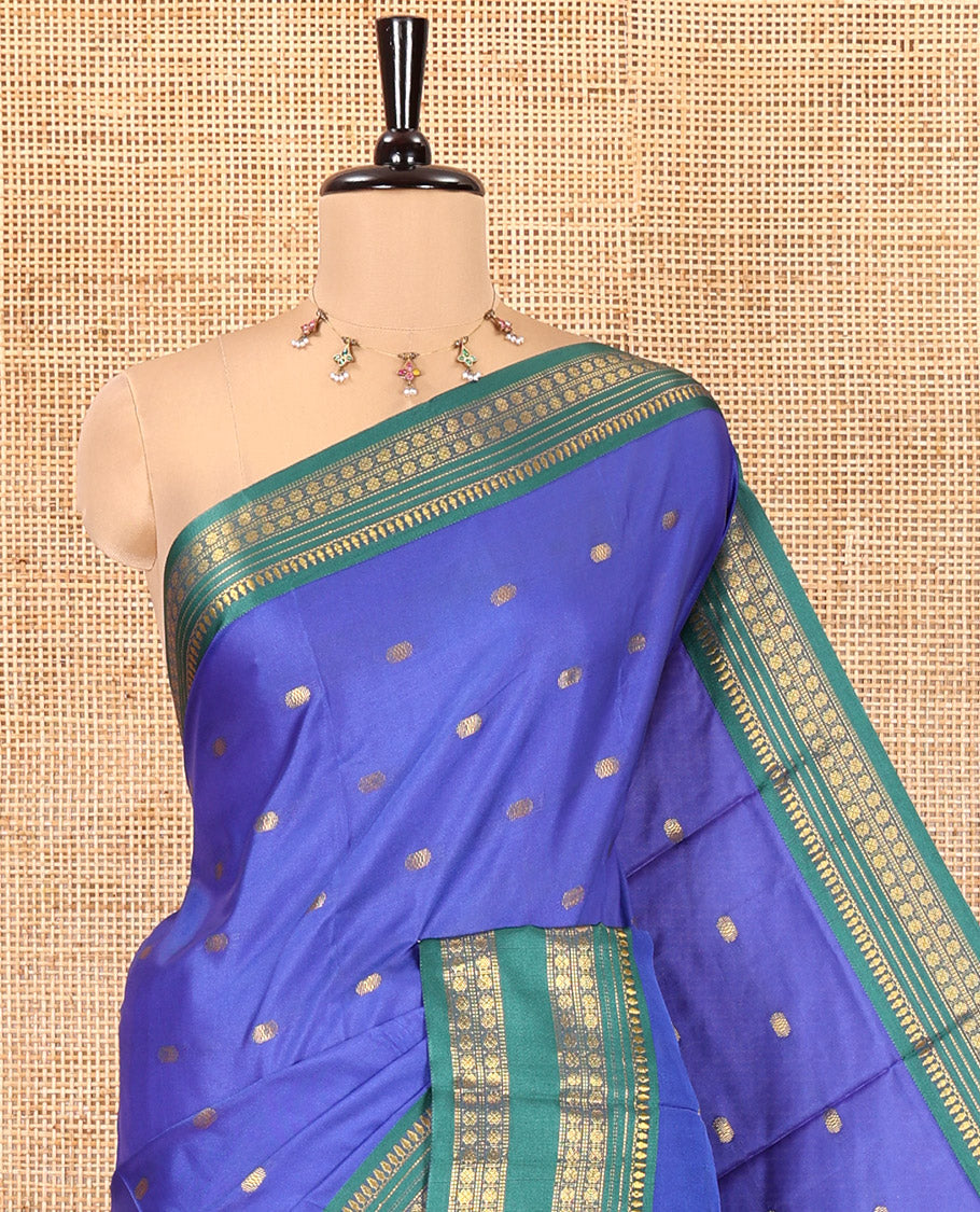 Royal Blue Softy Silk Saree, Accentuated with Zari Buttas All Over Its Body, Complemented by a Contrast Traditional Zari Design Rettai Pettu Border, Pallu Steeped with Buttas, and Paired with a Matching Blouse