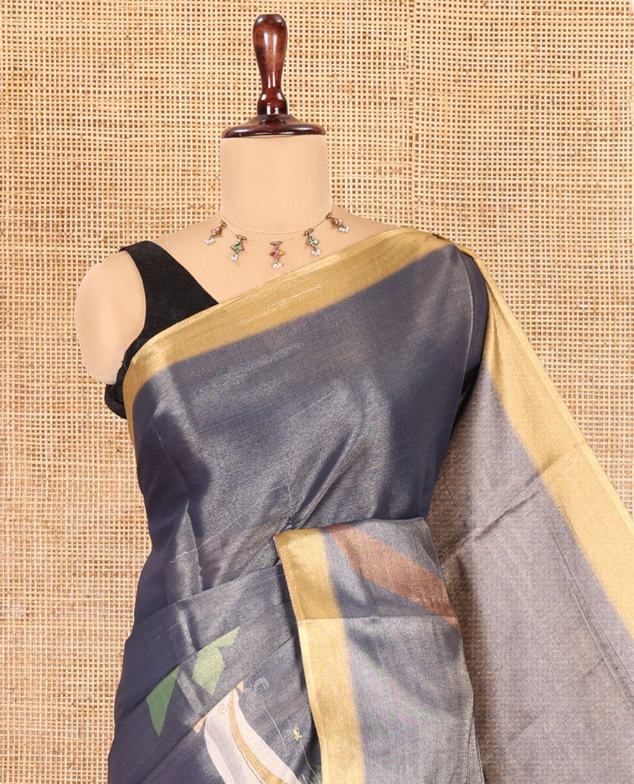 Denim Blue Kerala Culture-Themed Tissue Saree Features a Girl, Banana Leaf, and Kolam Motifs, Contrast Border, and Blouse