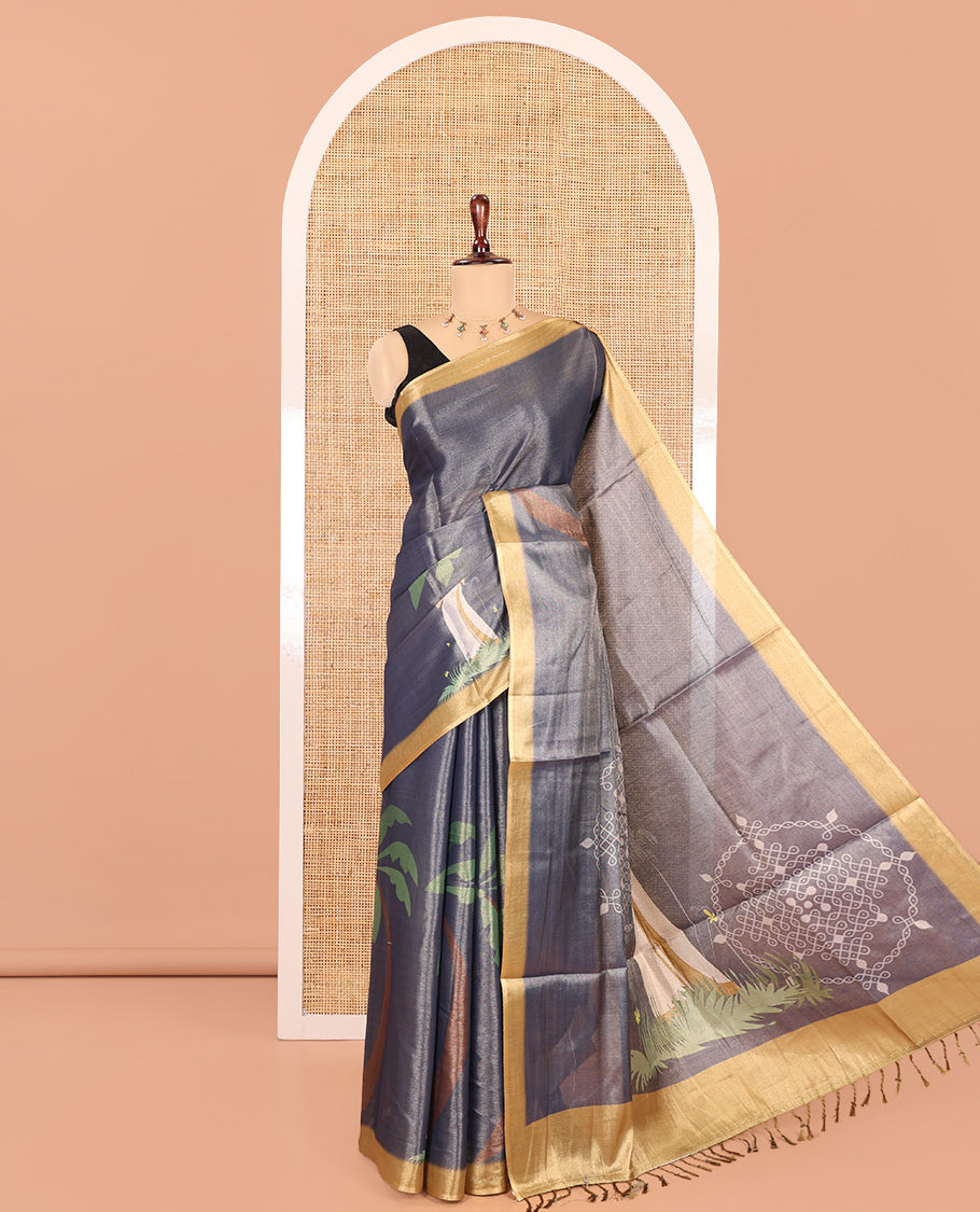 Denim Blue Kerala Culture-Themed Tissue Saree Features a Girl, Banana Leaf, and Kolam Motifs, Contrast Border, and Blouse