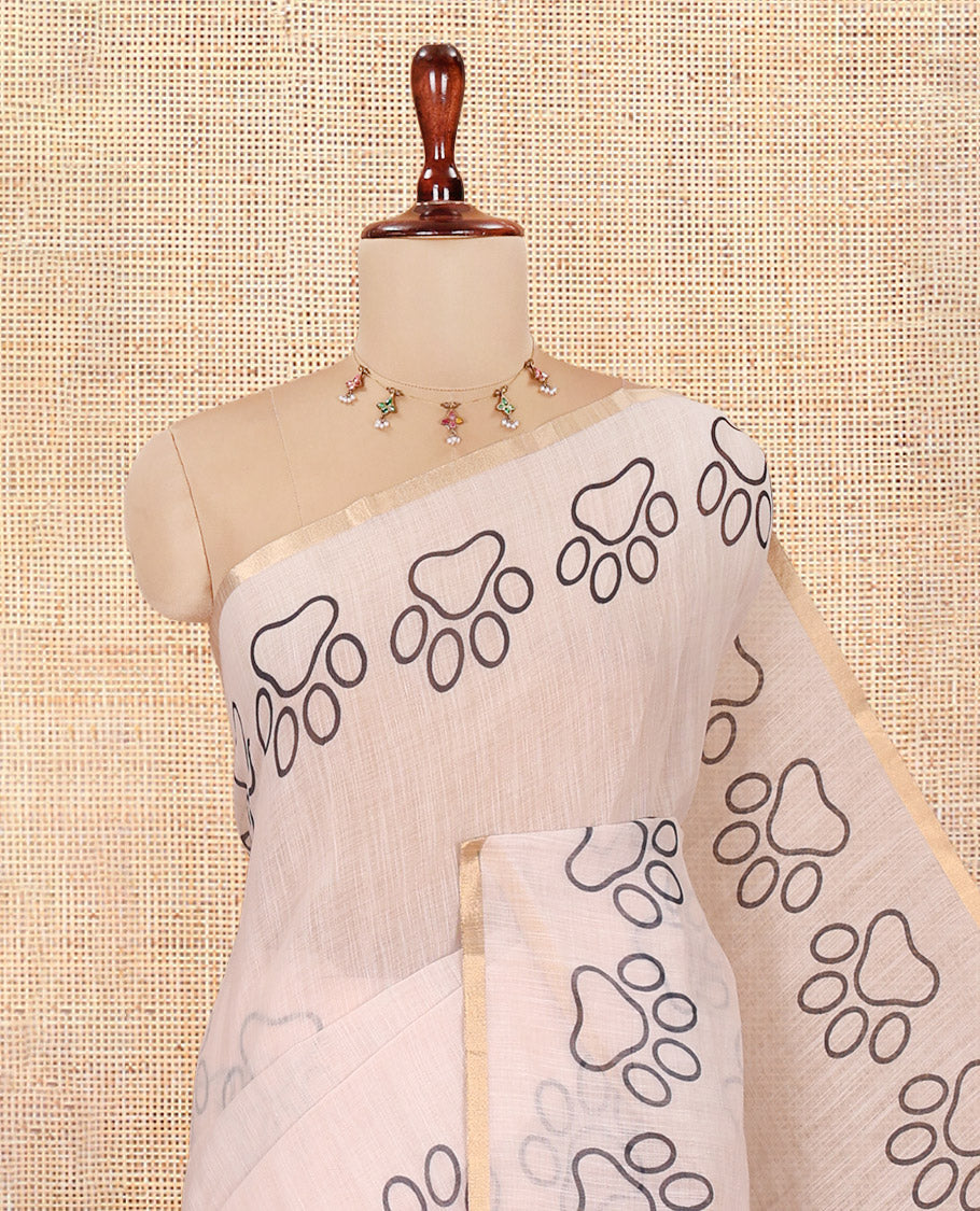 Cream Plain Linen Cotton Saree, a Dog Pow Printed Zari Border, Dog Motif Printed Pallu and a Matching Blouse