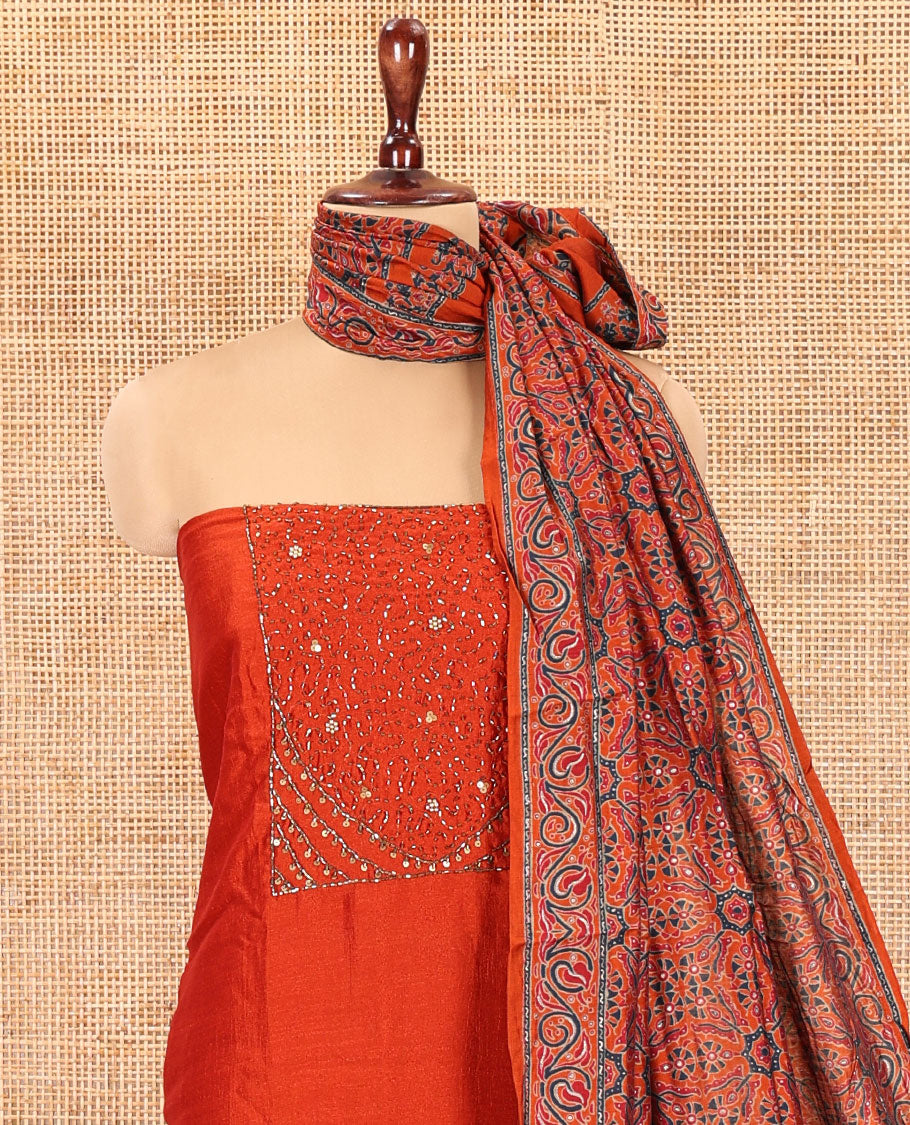 Rust Semi-Silk Material Chudidar Set Features Neck-Embroidered Top, a Santoon Bottom, and an Ajrakh Printed Dupatta