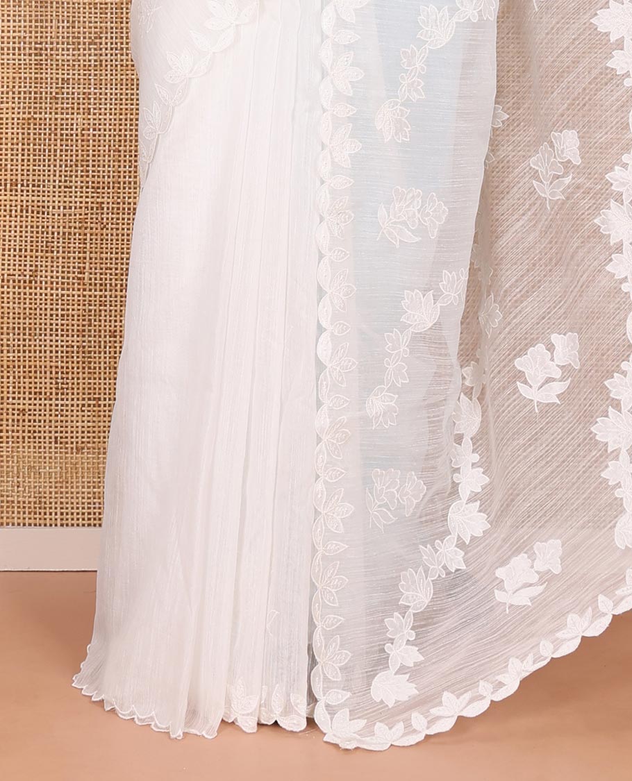 White floral motifs and diagonal floral creeper applique embroidered linen saree, scallop border, floral embroidered pallu, and a plain blouse
