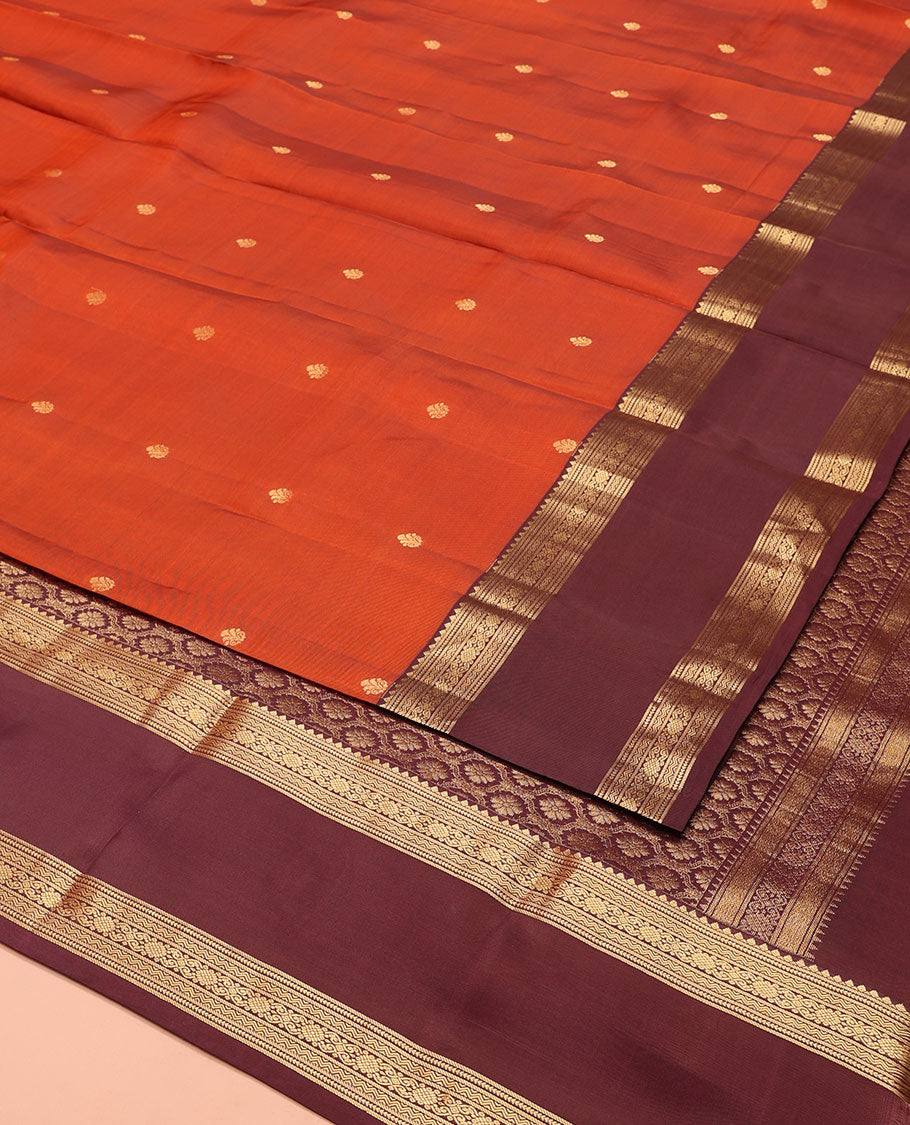 Orange Vasundhara Lite-Silk Mix Saree, Prettified with Zari Buttas, Complemented by Contrast Rettai Pettu Border Featuring Thilakam, Ara Bogudi, Neli, and Kamalam Designs, Grandly Woven Pallu of Floral Designs, and Paired with a Contrast Blouse