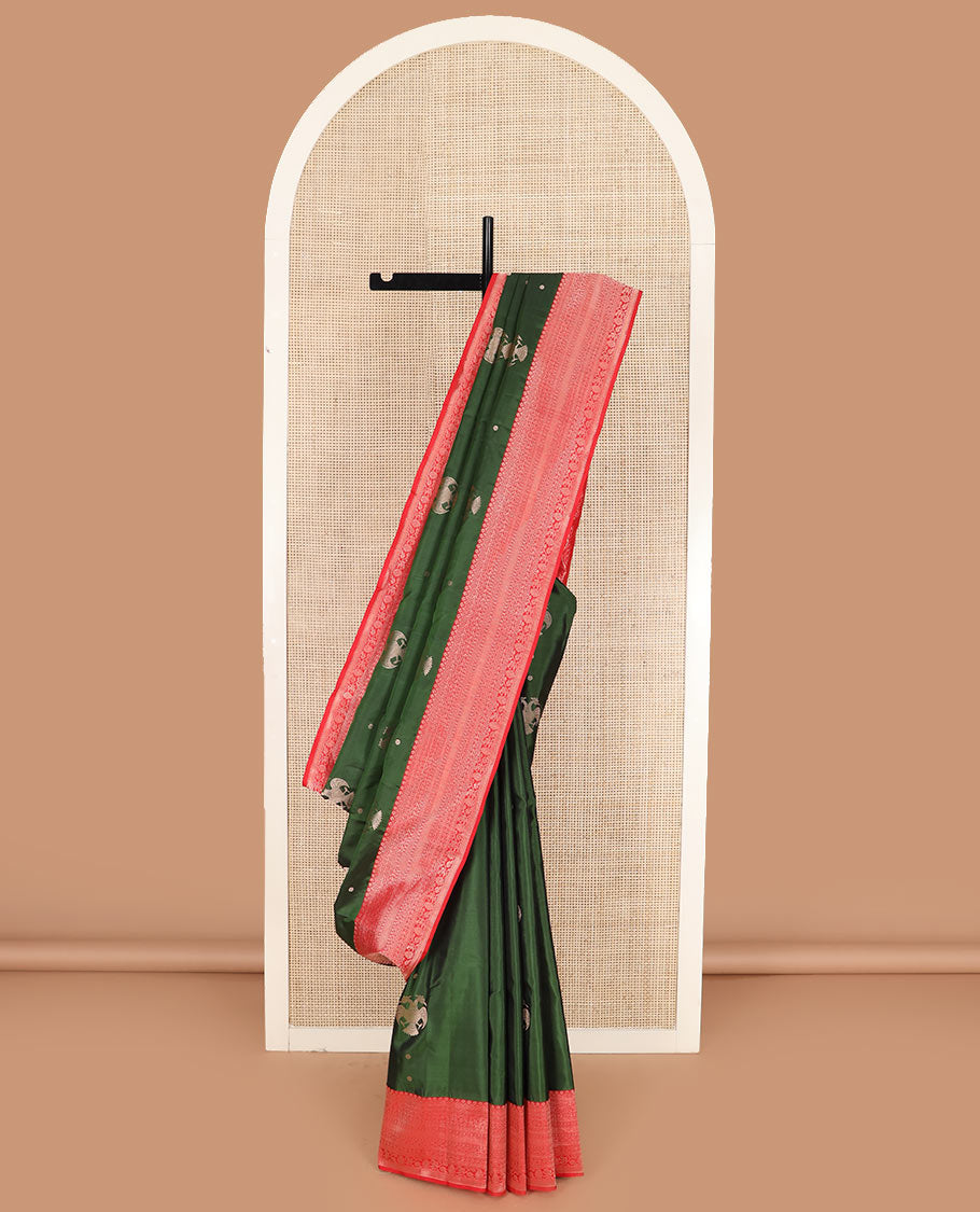 Green iruthalai pakshi buttas silk saree with contrast border of thilakam mokku, leaf vine, paisa, and kodi visiry designs, and intricate pallu