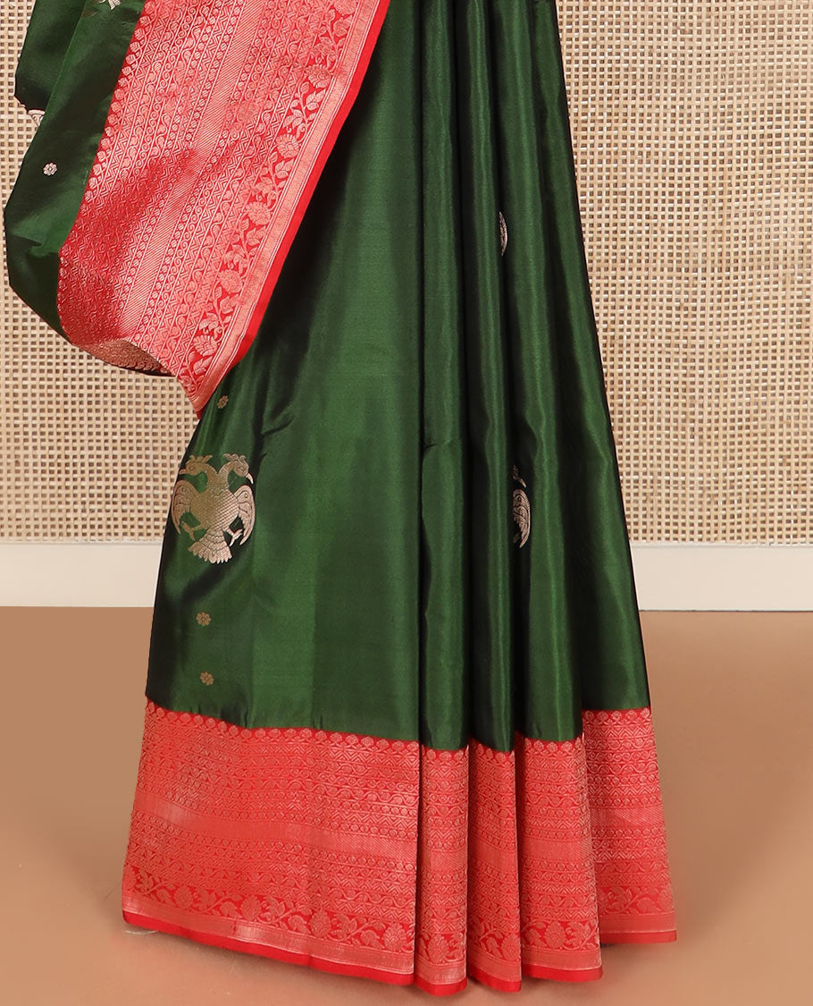 Green iruthalai pakshi buttas silk saree with contrast border of thilakam mokku, leaf vine, paisa, and kodi visiry designs, and intricate pallu