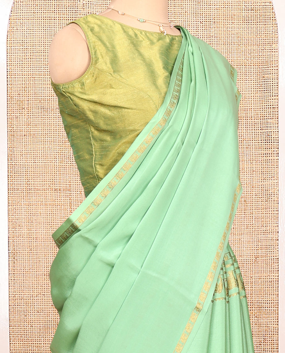 Green Plain Mysore Silk Saree, Highlighted by Traditional Zari Border of Elephant Motifs, Subtly Zari Striped Pallu, and Paired with a Matching Blouse