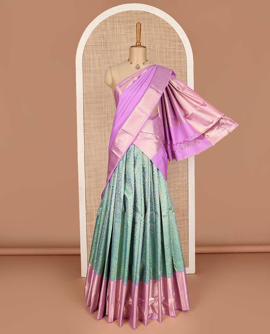 Green pure-silk half saree, jacquard with contrast traditional zari bordered skirt, blouse of thilakam, muthu, mayil kann, kodi visiry, and kamalam motifs, and zari design dhavani