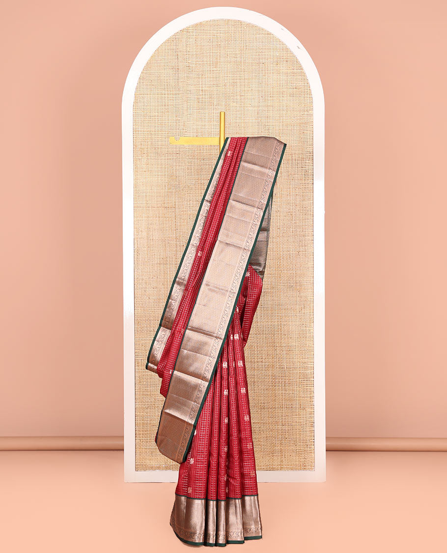 Red Vasundhara Silk Saree Embellished with Mayil-Yaali Buttas and Zari Checks, Complemented by a Contrast Border of Rekku, Muthu, Kuyil Kann, and Mayil Designs, Pallu Majestically Detailed with Geometric Designs, and Paired with a Matching Blouse