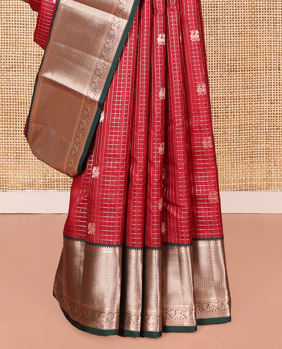 Red Vasundhara Silk Saree Embellished with Mayil-Yaali Buttas and Zari Checks, Complemented by a Contrast Border of Rekku, Muthu, Kuyil Kann, and Mayil Designs, Pallu Majestically Detailed with Geometric Designs, and Paired with a Matching Blouse