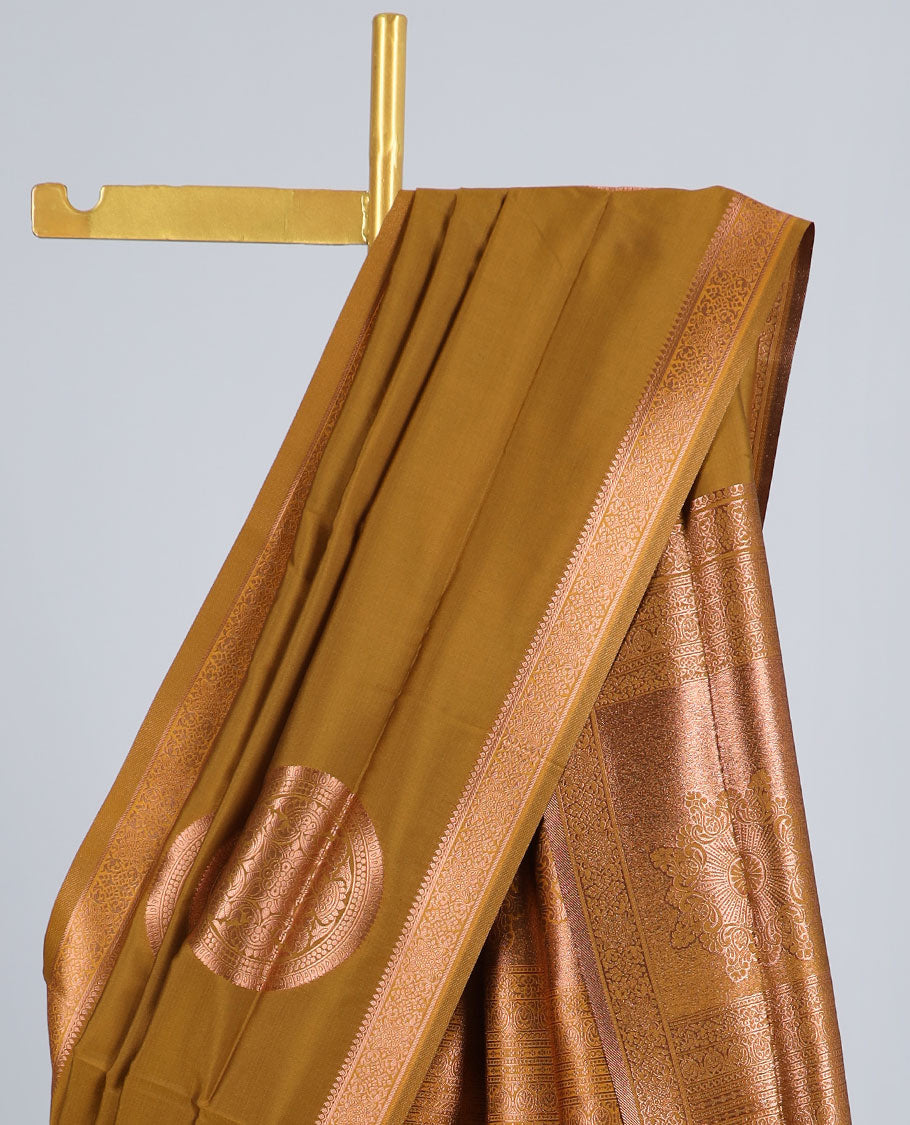 Dark mustard butter silk saree with chakram zari buttas, zari border & self-pallu of traditional designs
