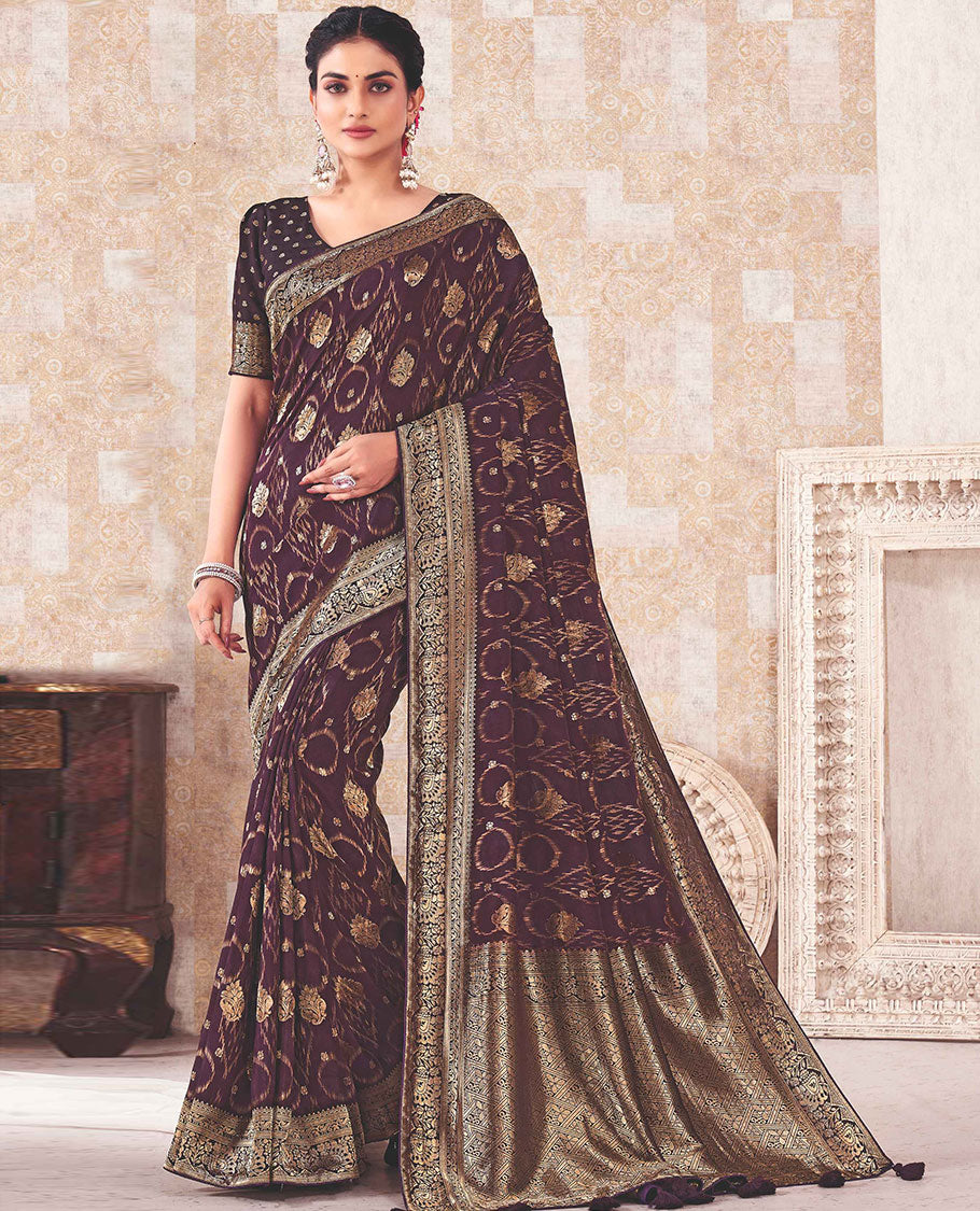 Purple saree with buttas, zari border & pallu features intricate floral designs