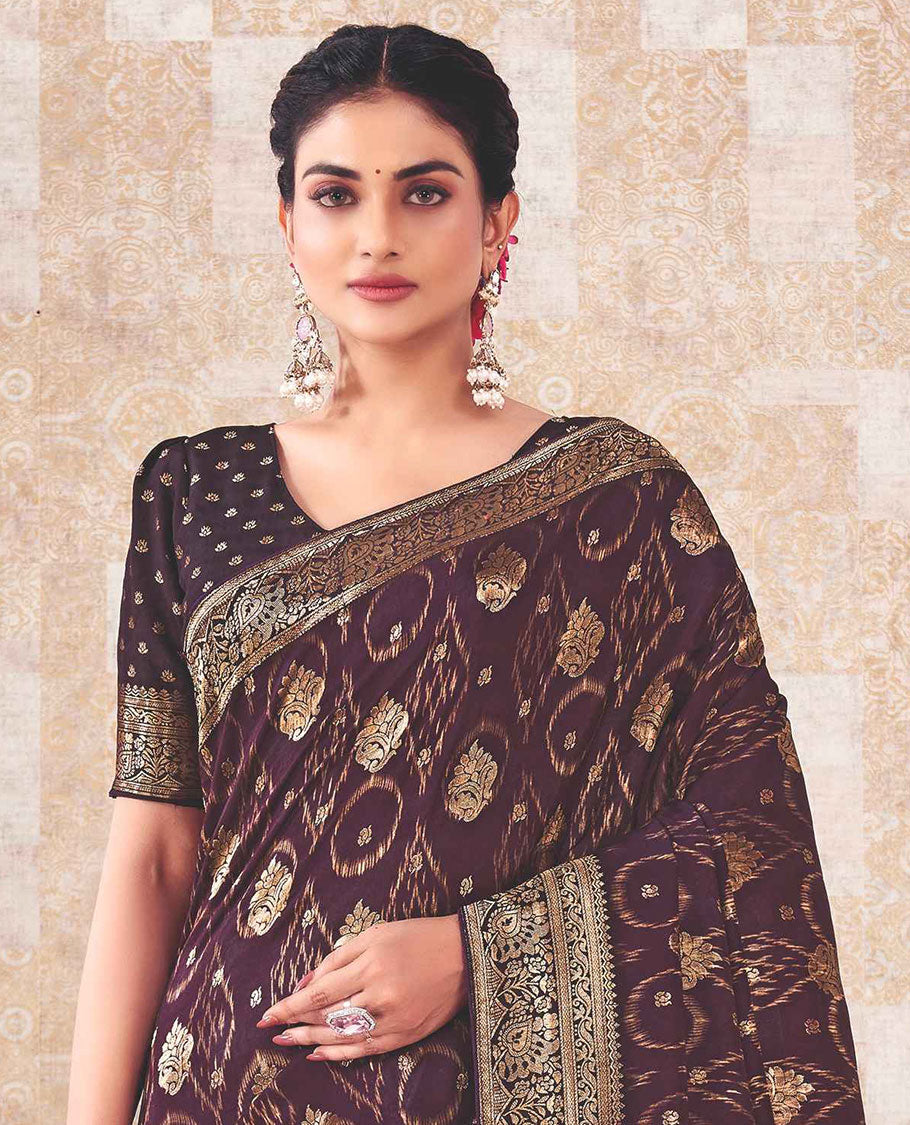 Purple saree with buttas, zari border & pallu features intricate floral designs