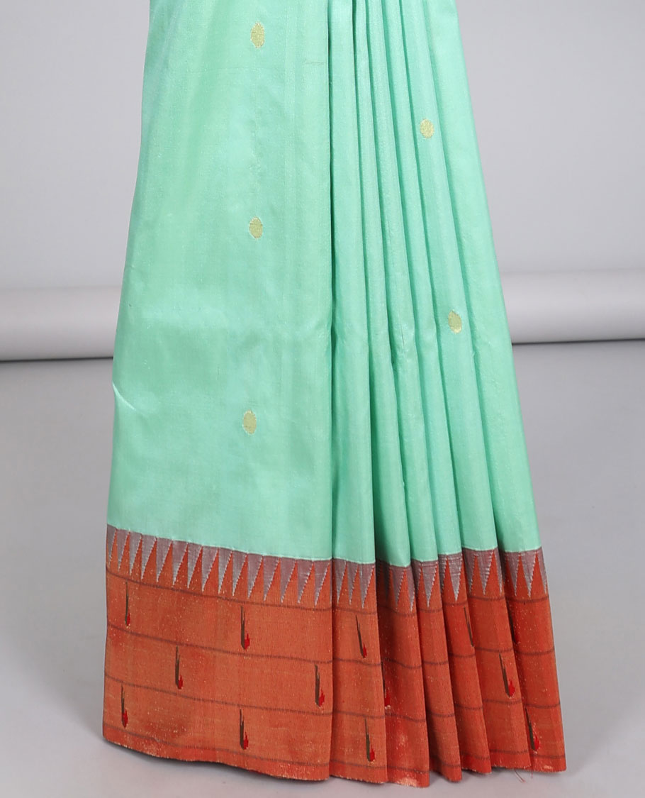 Green paithani silk saree with zari buttas, contrast vidarbha triple muniya border & pallu of colorful floral designs