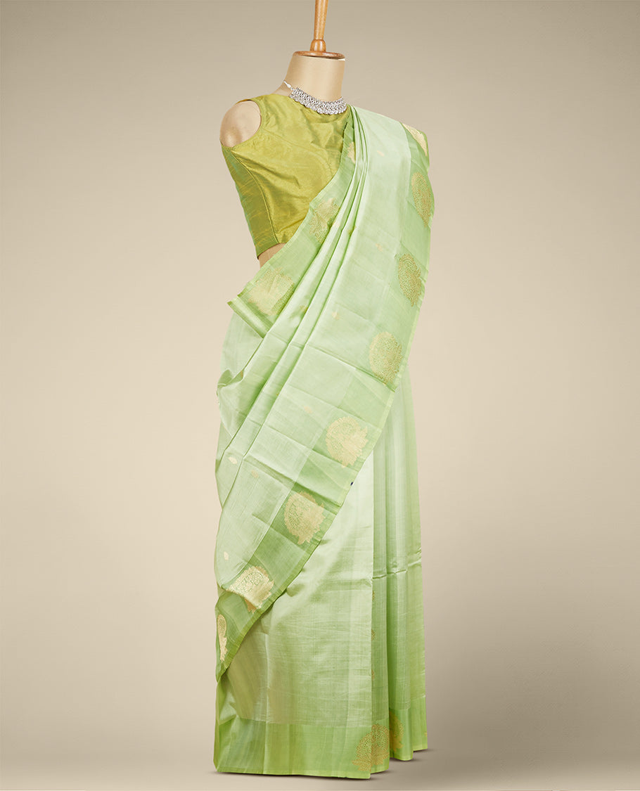 Green banaras raw mango silk saree with zari buttas, contrast border of intricate floral designs