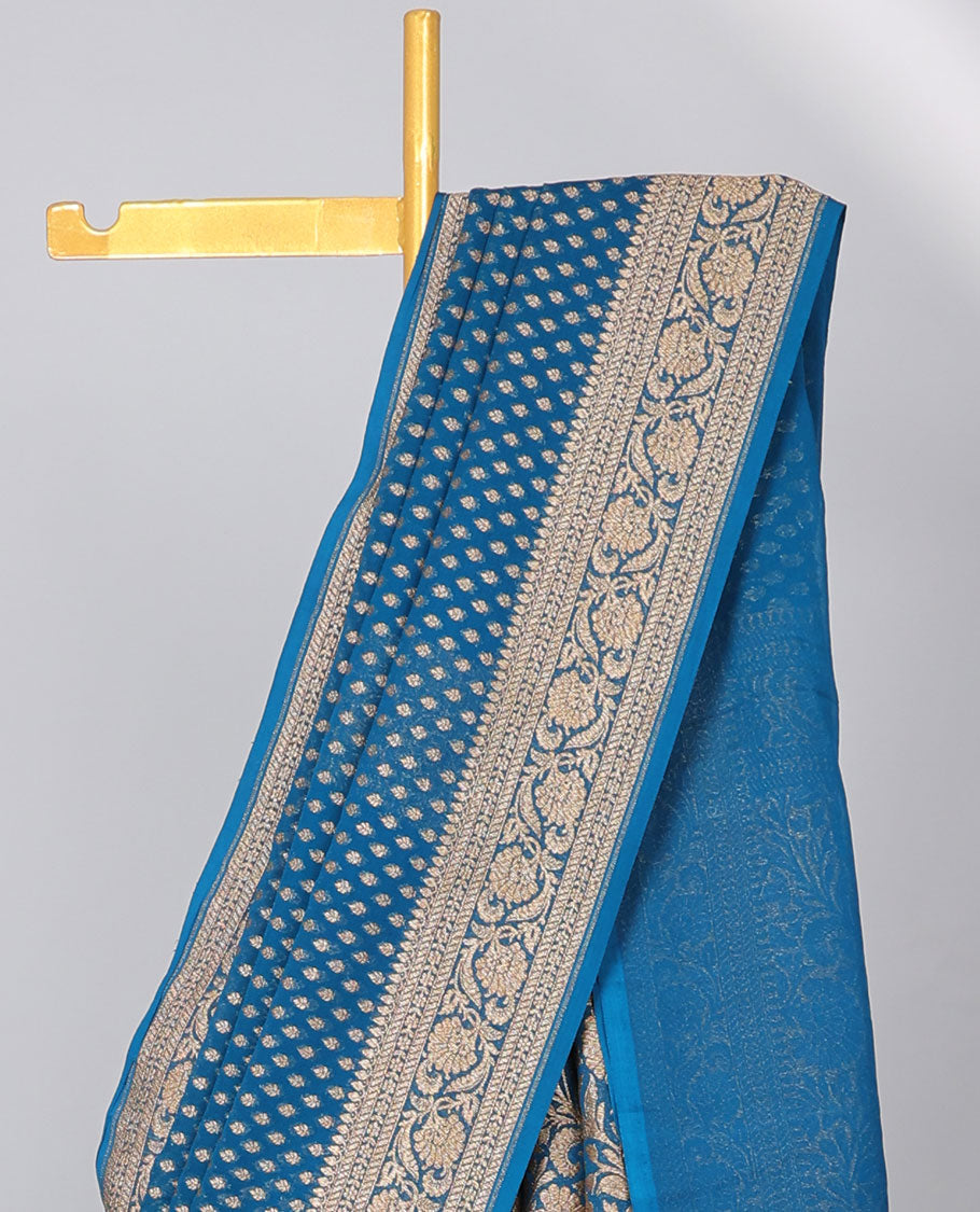 Blue khaddi georgette saree with buttas, floral jaal pallu & traditional border of floral creeper design