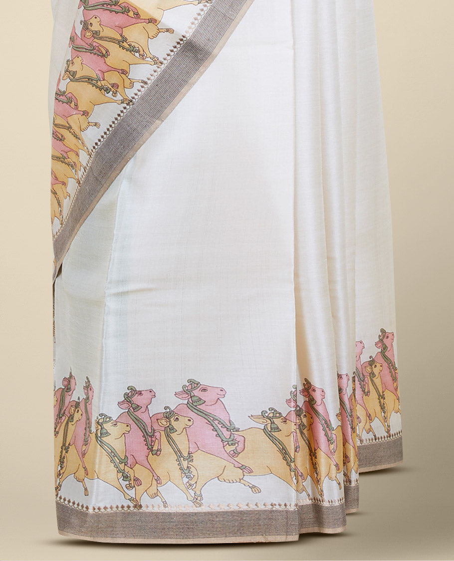 Cream plain design tusser silk saree features pichwai cow motifs, contrast border