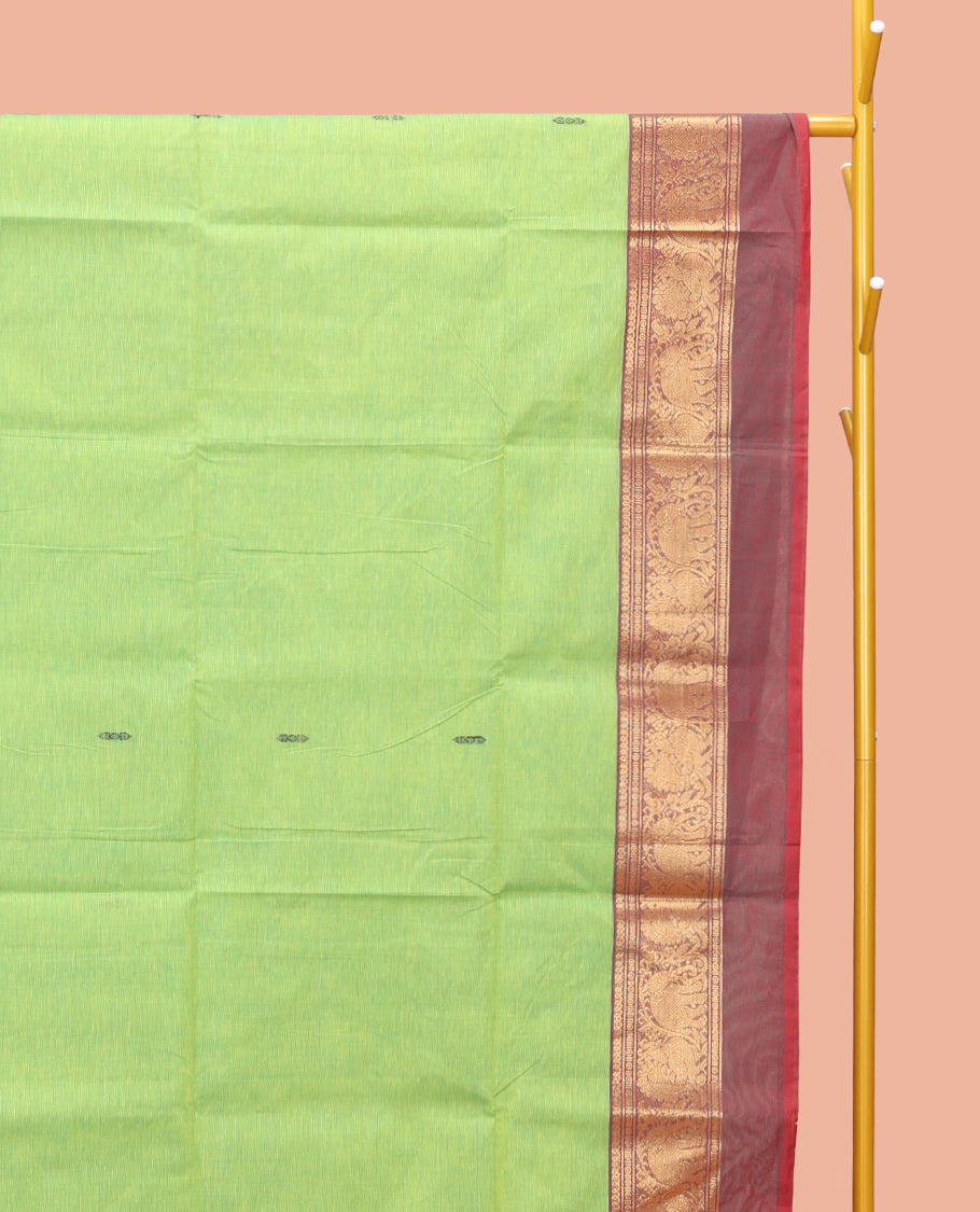 Pista Green Chettinad Cotton Saree, Decorated with Thread Buttas All Over Its Body, Complemented by a Contrast Ganga-Jamuna Kal Eragina Border of Kodi Peacock and Elephant Designs, Pallu of Buttas and Stripes, and Paired with a Matching Blouse