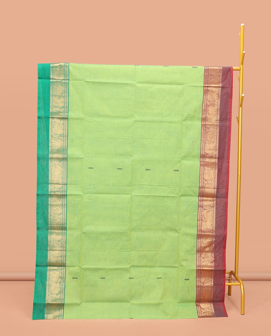 Pista Green Chettinad Cotton Saree, Decorated with Thread Buttas All Over Its Body, Complemented by a Contrast Ganga-Jamuna Kal Eragina Border of Kodi Peacock and Elephant Designs, Pallu of Buttas and Stripes, and Paired with a Matching Blouse
