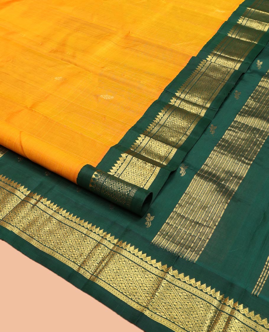 Yellow Kanchipuram Silk Saree, Sparsely Sparkled with Zari Buttas on Its Body, Complemented by a Contrast One-Sided Korvai Border of Thilakam Mokku, Banaras, Muthu, and Kamalam Designs, Pallu Features Zari Designs, and Comes Without a Blouse
