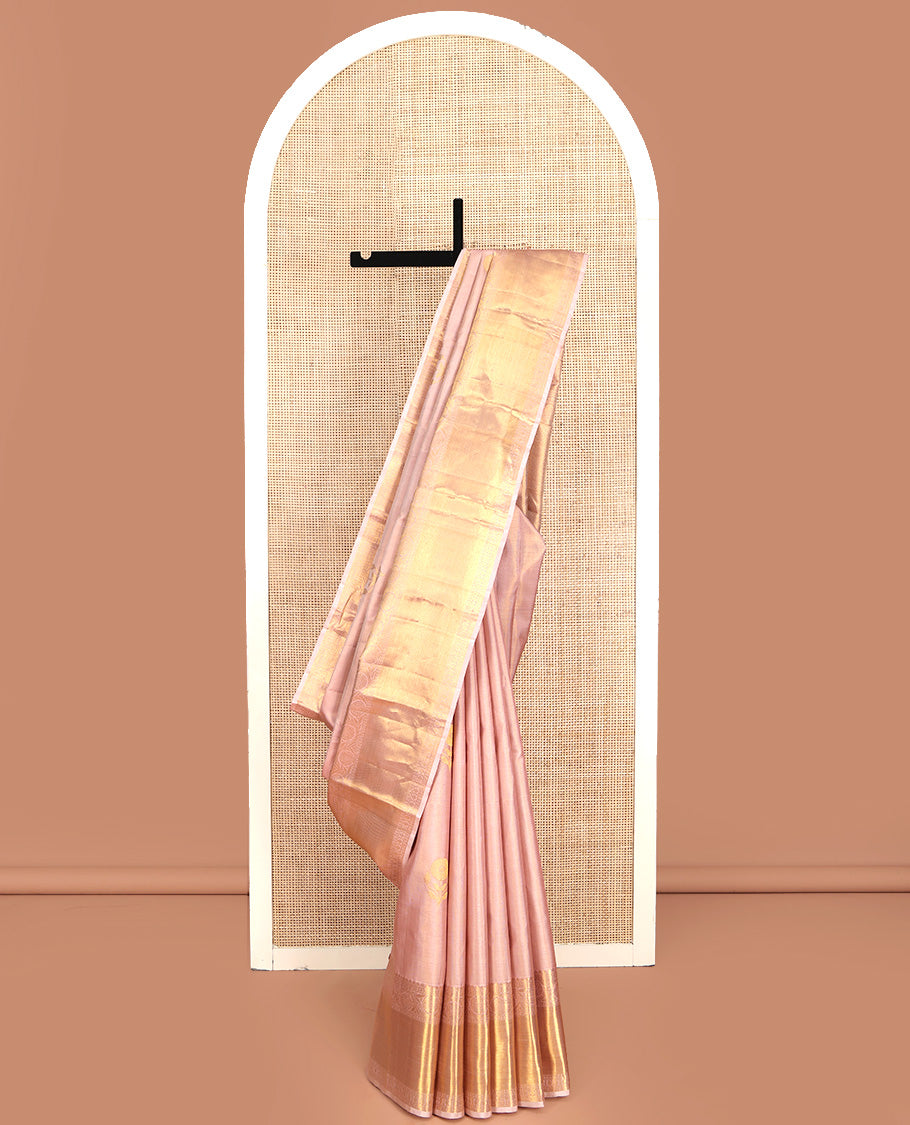 Rose Gold Kanchipuram Silk Saree, Delicately Woven with Floral Buttas All Over Its Body, Highlighted by Zari Border of Thilakam Mokku, Neli, Poun, and Kodi Visiry Designs, Gleaming Pallu, and Paired with a Matching Blouse