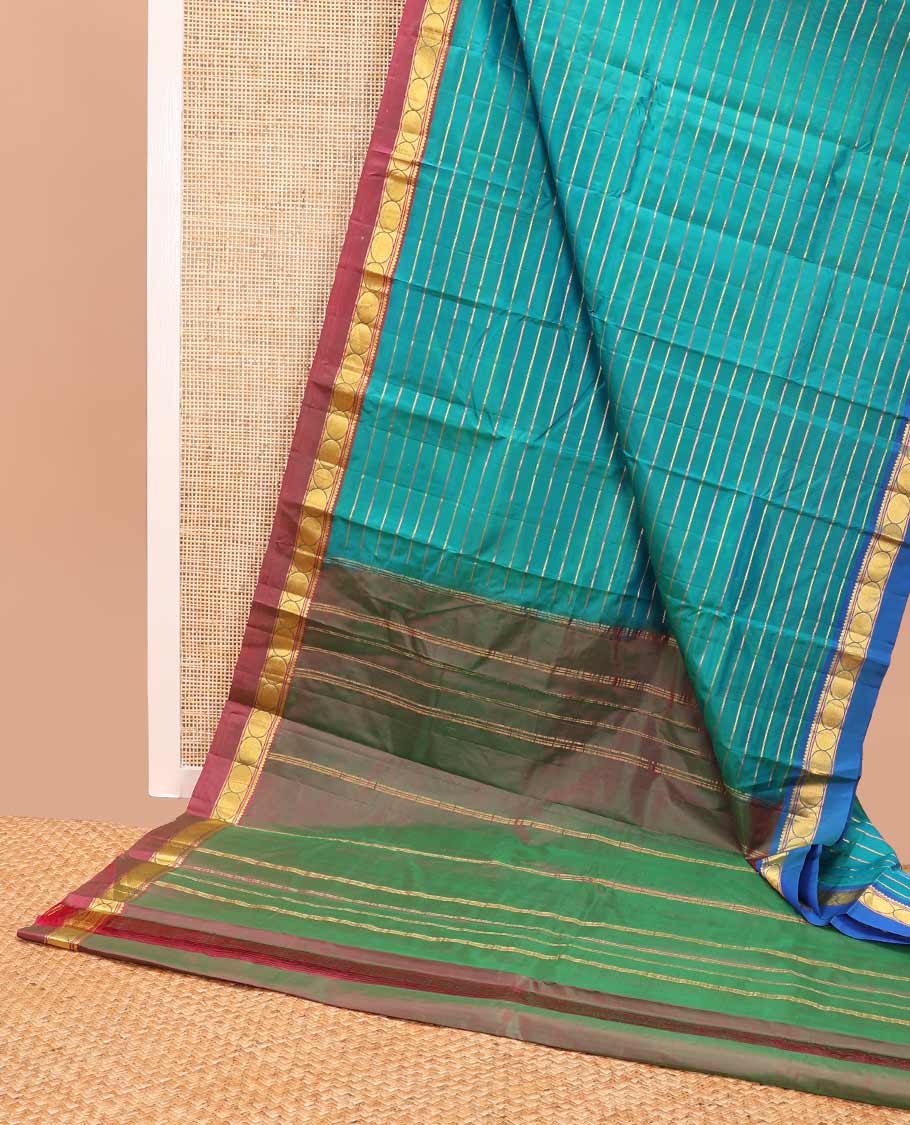 Dark blue striped kancheepuram with contrast border of paisley, muthu, kathir design & zari design pallu