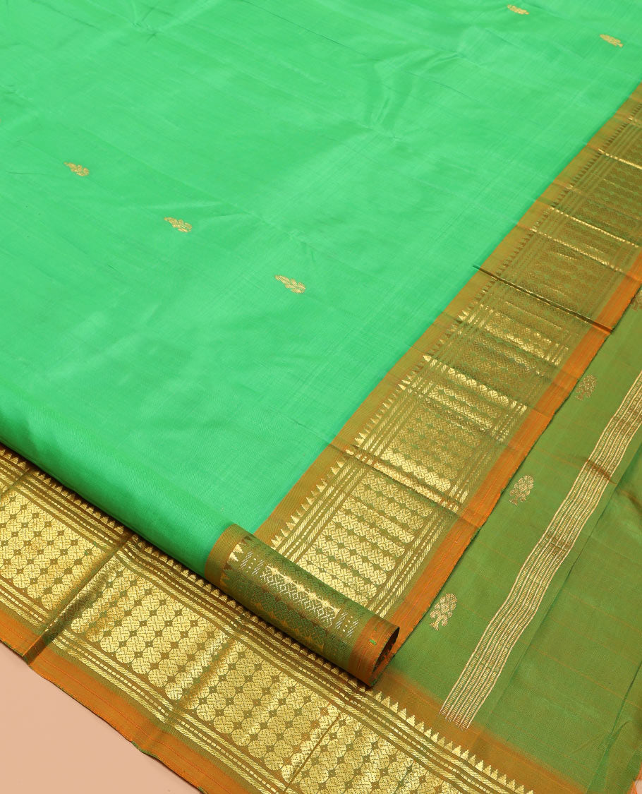 Green Kanchipuram Silk Saree, Styled with Zari Buttas, a Contrast One-Sided Border of Rekku, Banaras, and Rudraksham Designs, Zari Design Pallu, and a No Blouse