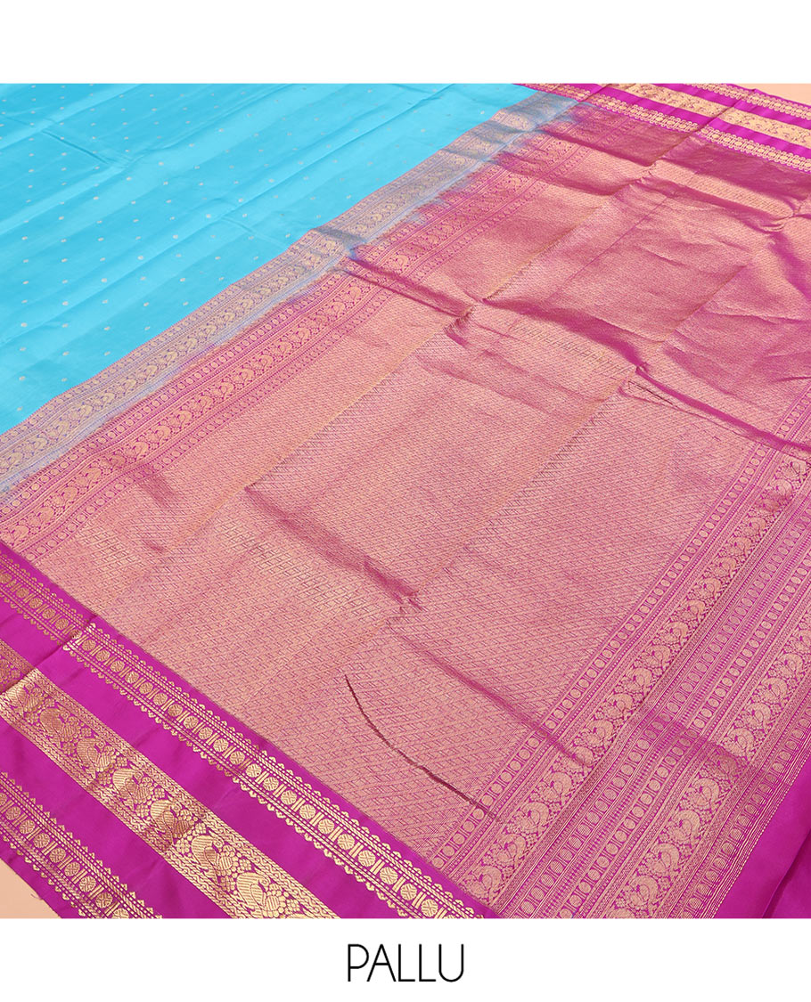 Blue Vasundhara Silk Saree Gracefully Embellished with Zari Buttas, Complemented by a Varisai Pettu Border Featuring Rekku, Muthu, Banaras, Rudraksham, and Mayil Designs, Majestically Woven with a Zari-Designed Pallu, and Paired with a Contrast Blouse