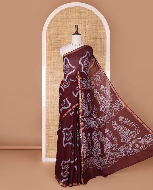 Wine batik geometric printed pure cotton saree, zari piping border, human figurines batik printed pallu, and a matching batik printed blouse