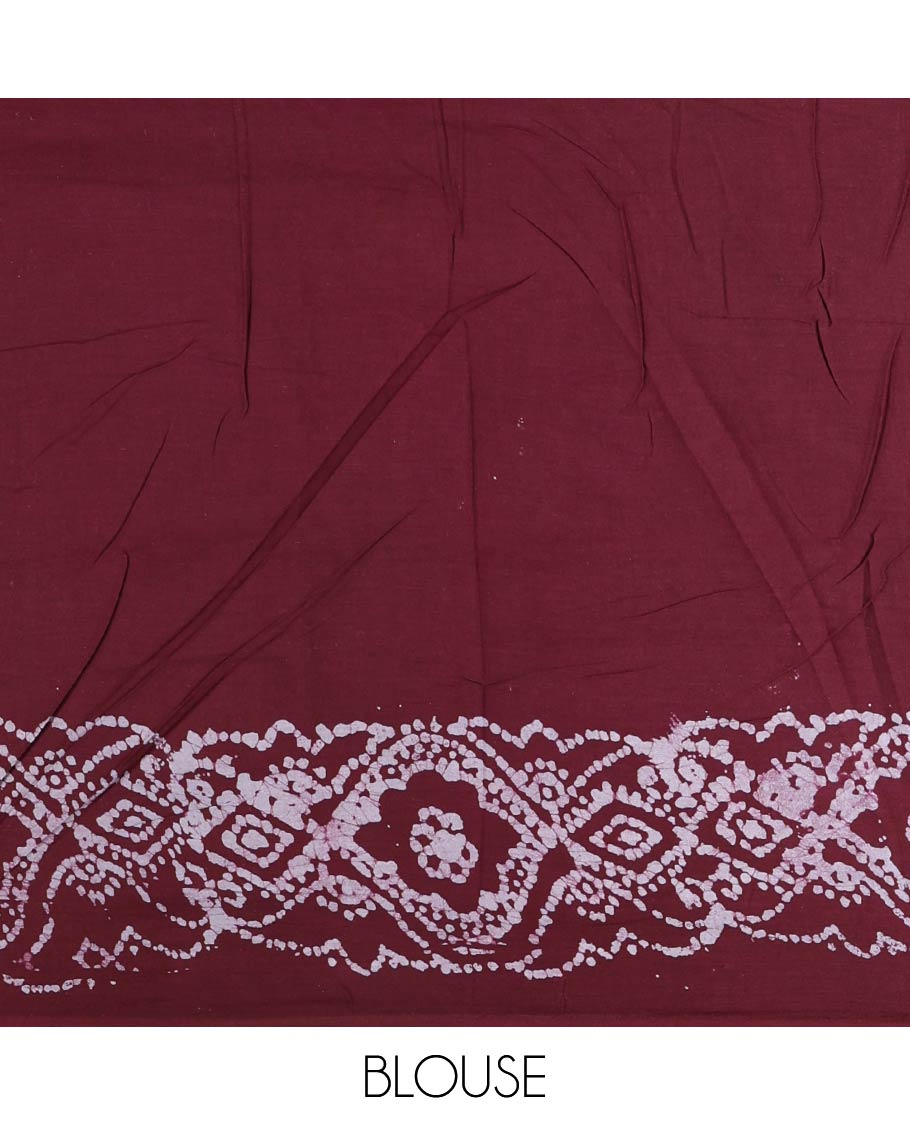 Wine batik geometric printed pure cotton saree, zari piping border, human figurines batik printed pallu, and a matching batik printed blouse