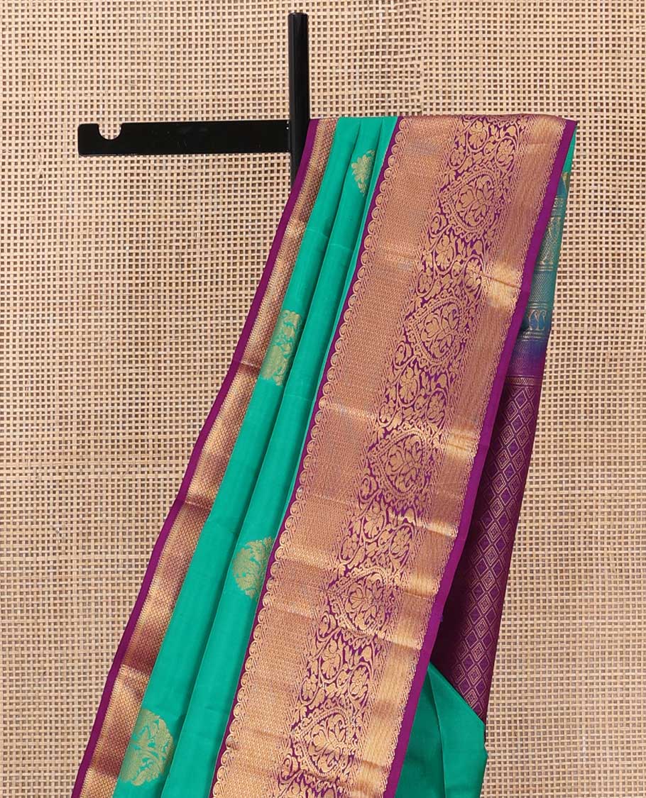 Turquoise blue zari buttas silk saree, contrast border of traditional zari designs, and jaal pallu