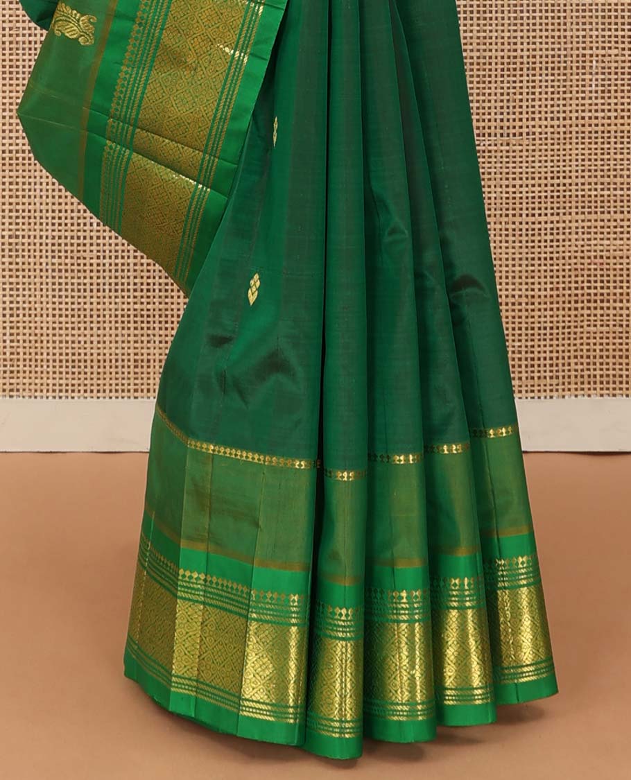 Green zari buttas Kanchipuram silk saree, contrast one-sided border of paneer sombu, banaras, muthu, and jaal designs, and floral-geometric pallu