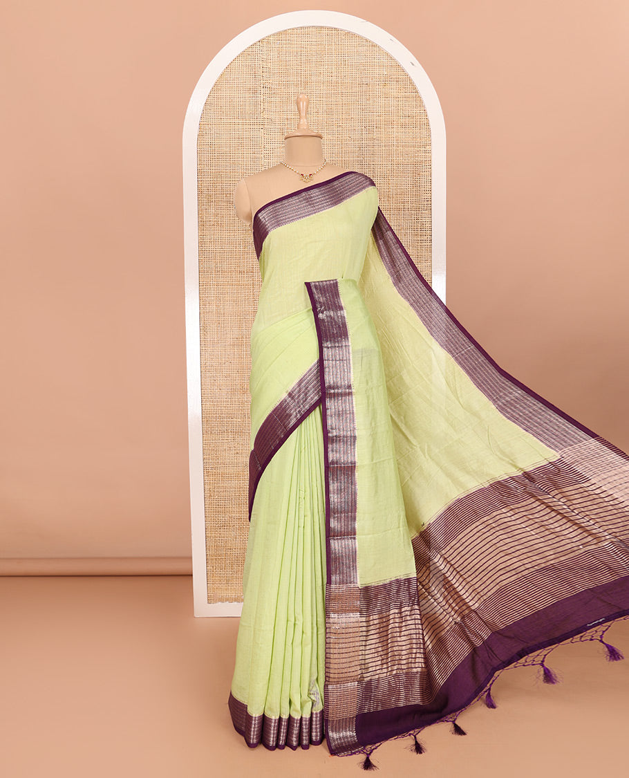Green Assam Silk Saree Features Sparsely Woven Buttas, Complemented by Contrast Traditional Zari Design Border, Pallu Elevated with Zari Stripes, and Paired with a Contrast Blouse
