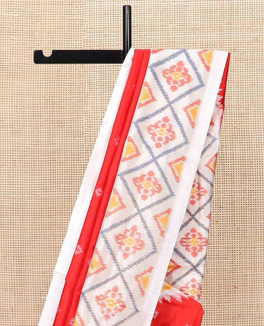 Red Ikkat Silk Saree with Ikkat Buttas, Accentuated with a Contrast Ikkat Jaal-Patterned Border, Pallu Features Ikkat Jaal Patterns, and with a Contrast Blouse