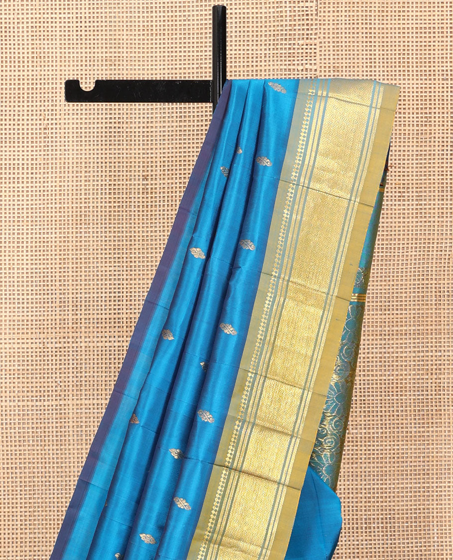 Blue Kanchipuram Silk Saree, Gleamed Up with Zari Buttas, a Contrast One-Sided Border of Panner Sombu, Banaras, and Jaal Designs, a Zari Design Pallu, and No Blouse