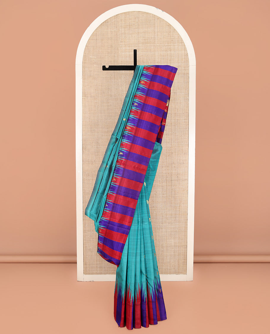 Blue Kanchipuram Silk Saree, Elevated with Zari Buttas on Its Body, Complemented by a Contrast One-Sided Thazampoo Rekku Border of Zari Buttas, Pallu Steeped with Zari Designs, and Comes Without a Blouse