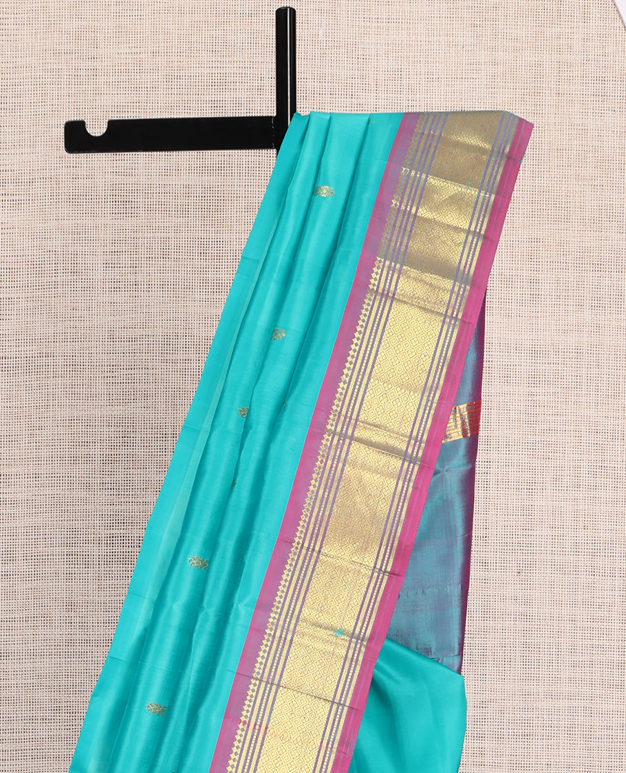 Blue Kanchipuram Silk Saree, Ornamented with Zari Buttas, a Contrast One-Sided Border of Paneer Sombu, Banaras, Muthu and Jaal Design, Zari Design Pallu, and No Blouse