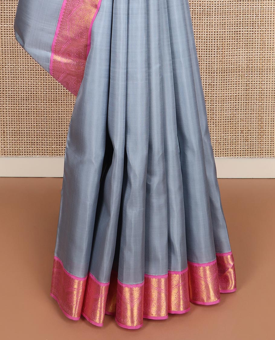 Grey plain Kanchipuram silk saree, contrast korvai zari border, and pallu steeped with traditional designs