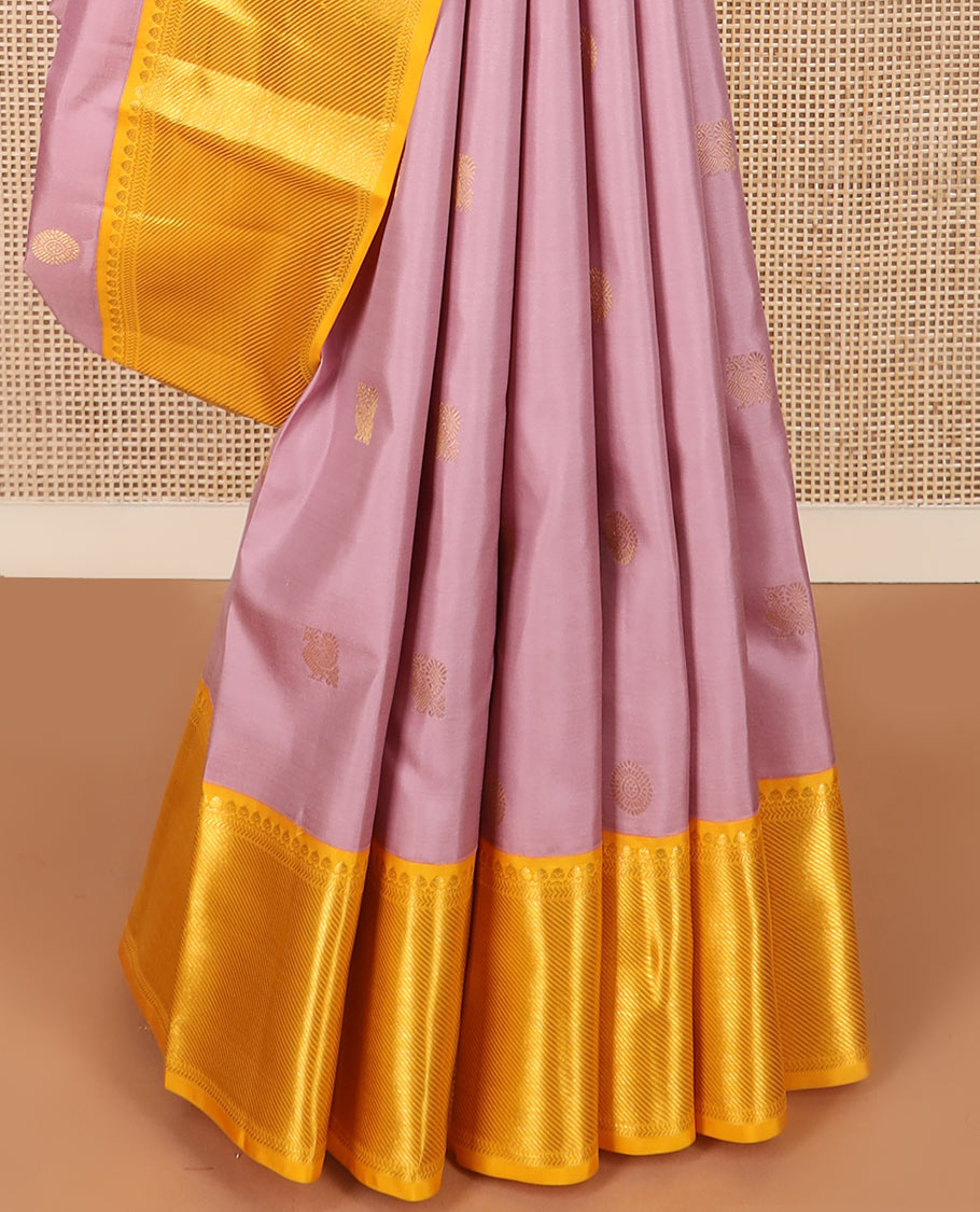 Pink mayil chakram buttas Kanchipuram silk saree, contrast border of thilakam mokku, kathir, and zari stripes, and intricate pallu